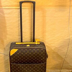 Louis Vuitton 22 inch roller bag!! She’s never been on a plane. Road trips only!